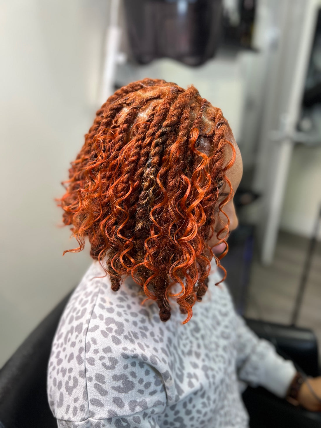 Shoulder-length micro locs with defined parting after professional retightening